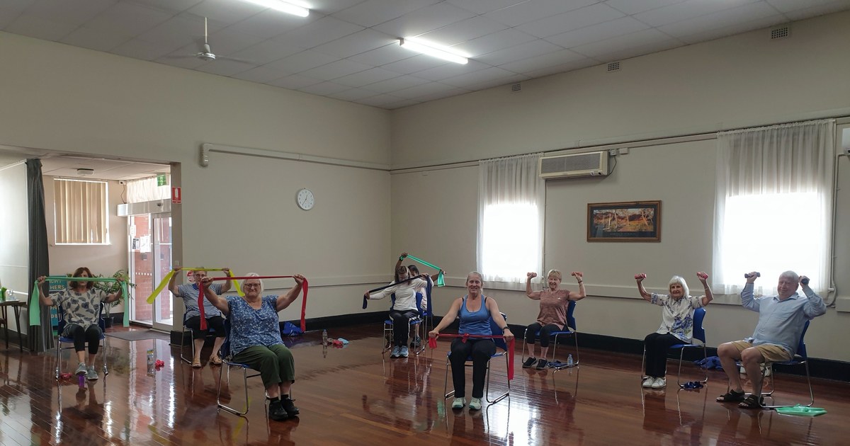 Group of seniors doing a seated exercise class together