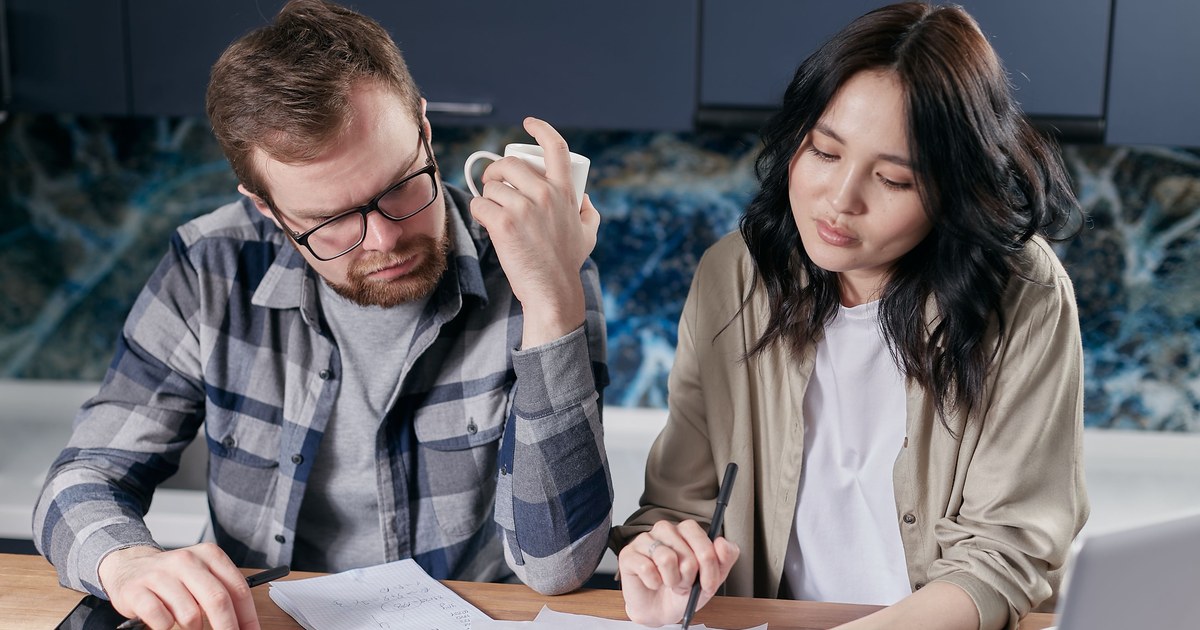 Couple reviewing household budget and bills at home