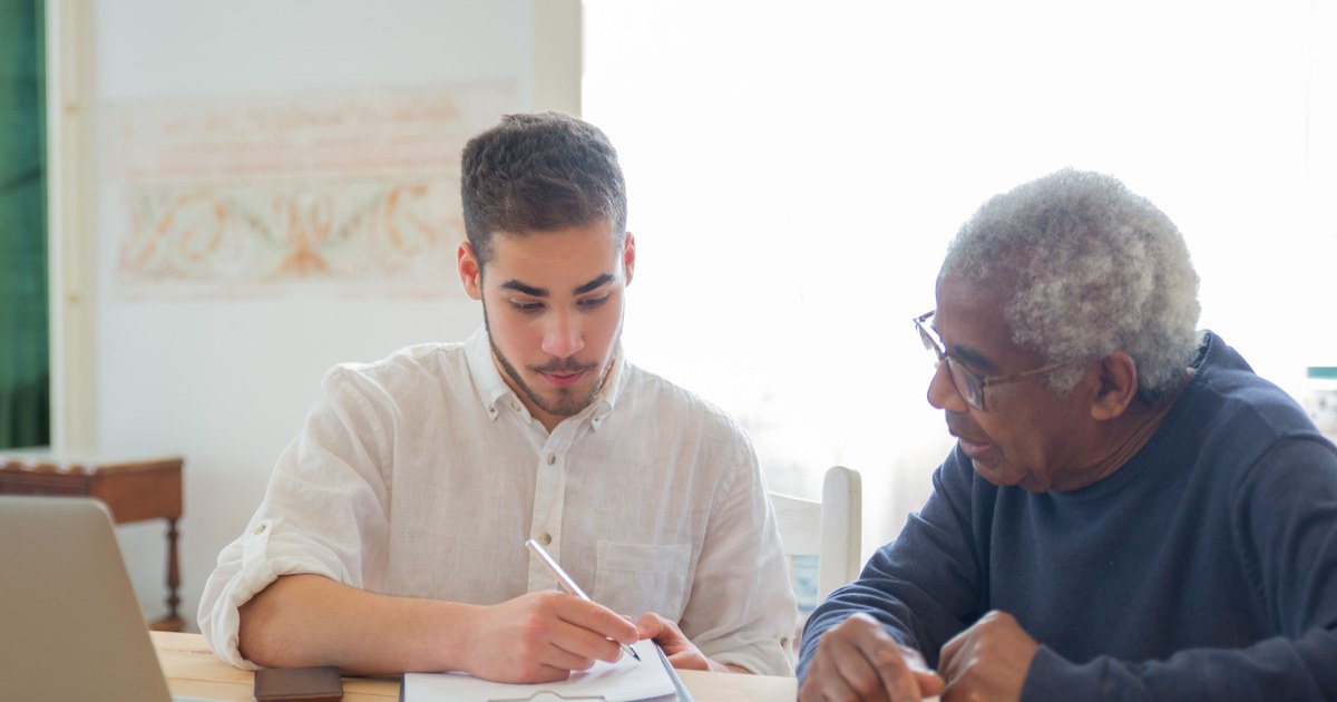 Adult child helping a senior parent review Medicaid paperwork at home