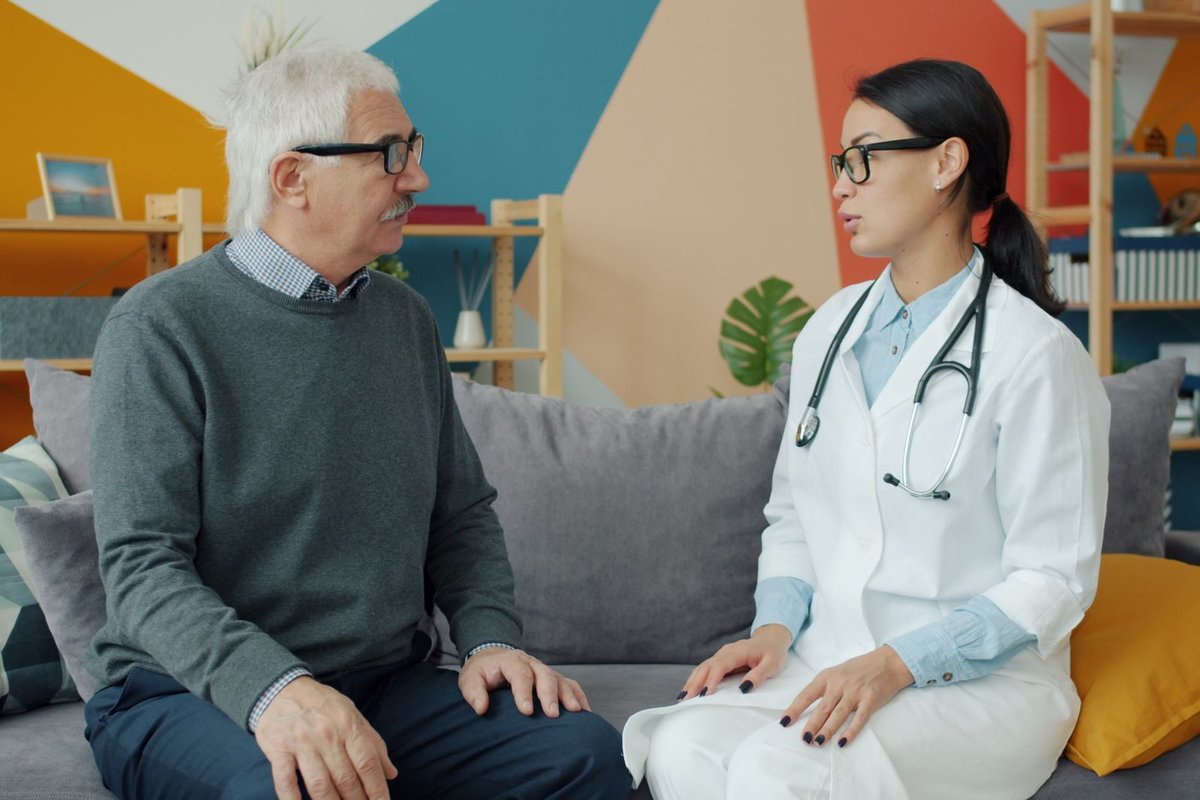 Doctor and older man talking face to face during a medical consultation about memory concerns