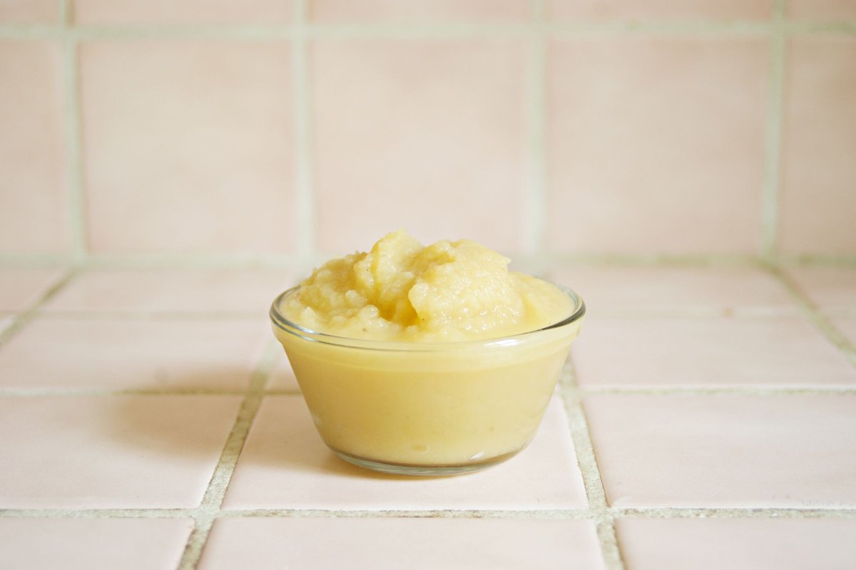 Small glass bowl of smooth soft puree on a pink tiled counter