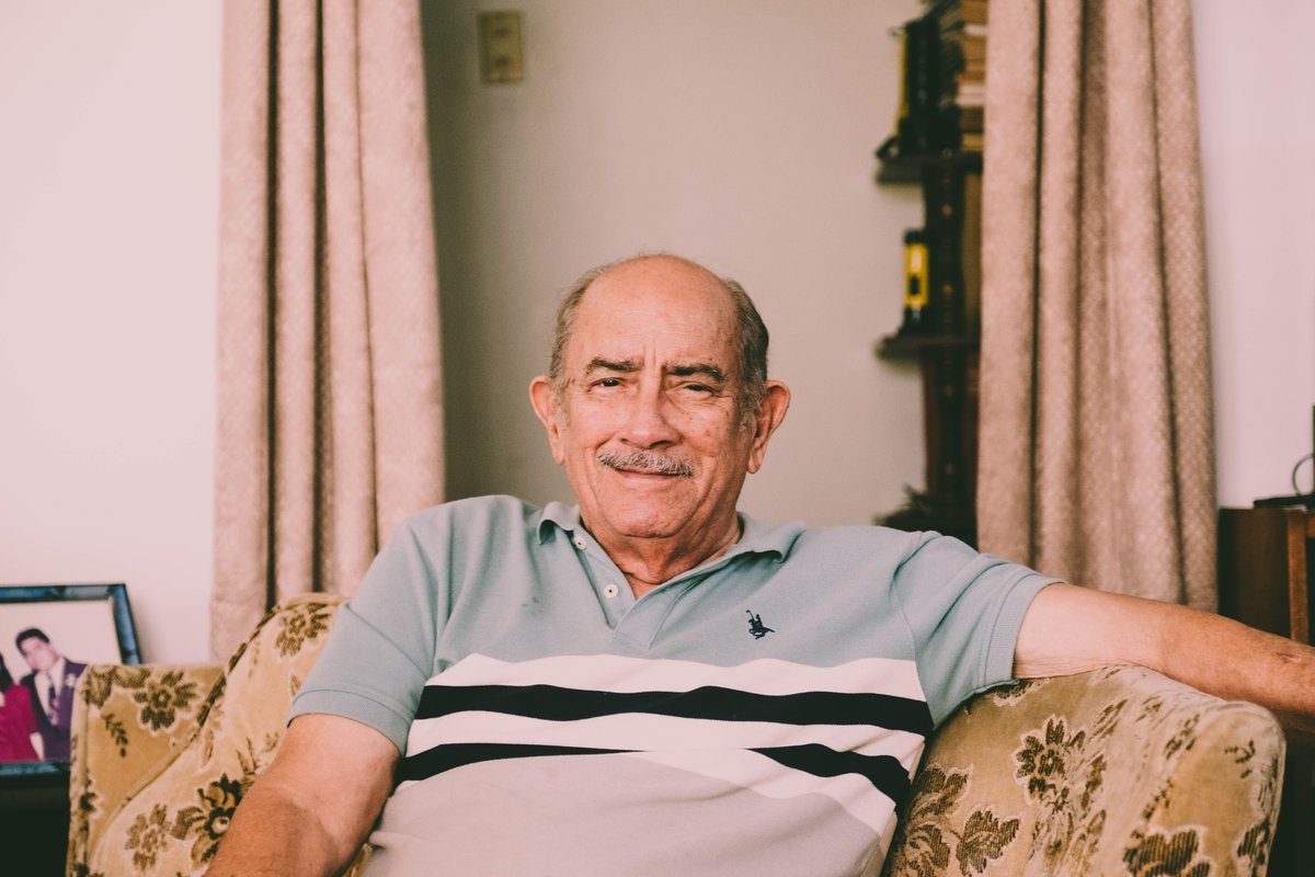 Smiling older man relaxing in an armchair in his living room